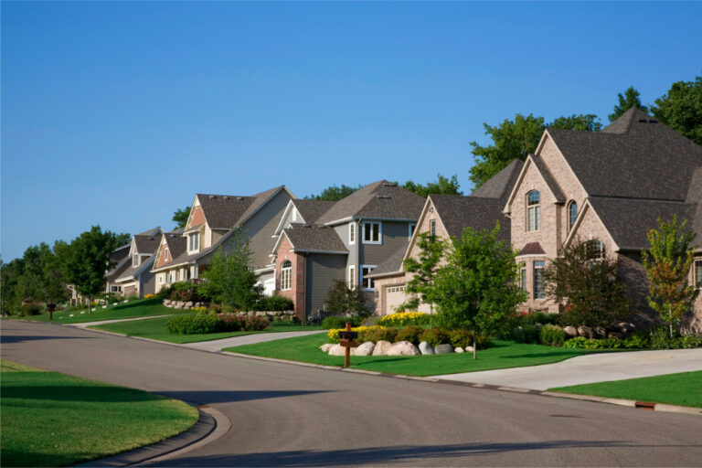 A row of houses on the side of a street.