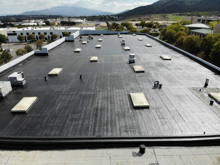 A large black roof with many white boxes on it.