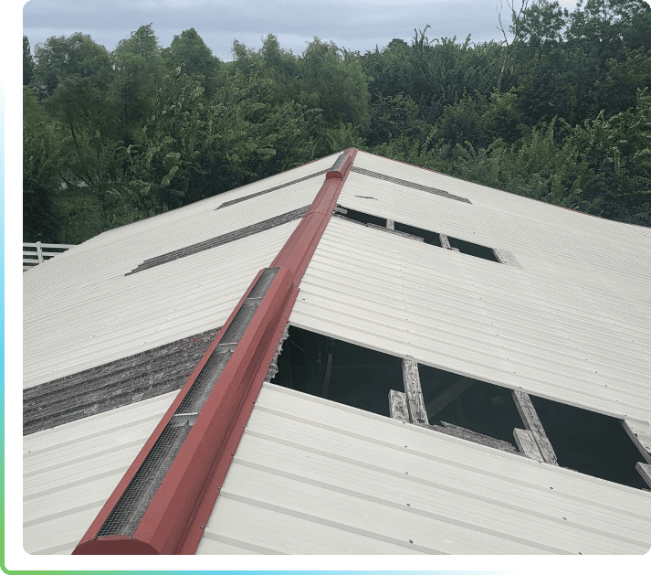 A red and white roof with trees in the background
